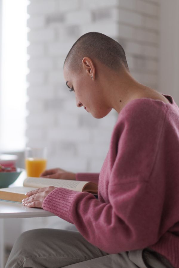 image of a woman with a shaved head receiving iv therapy in boise