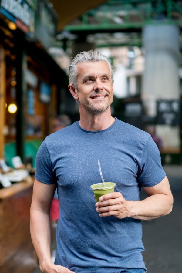 image of a man walking through a city after iv therapy